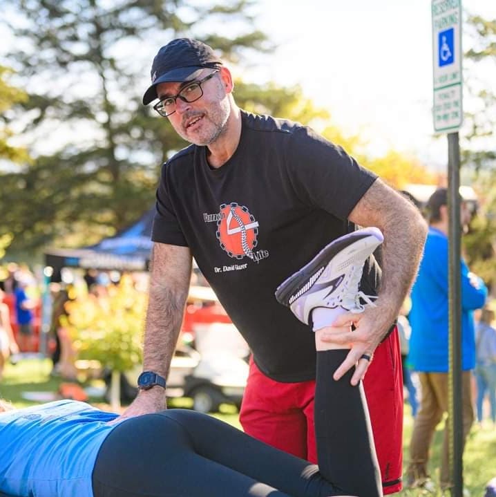 Dr. Glaser working on patient at a race