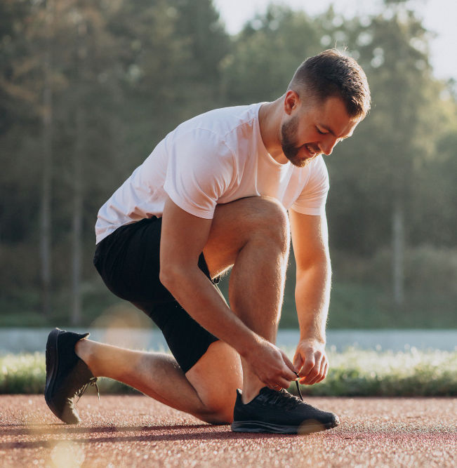 man tying shoe