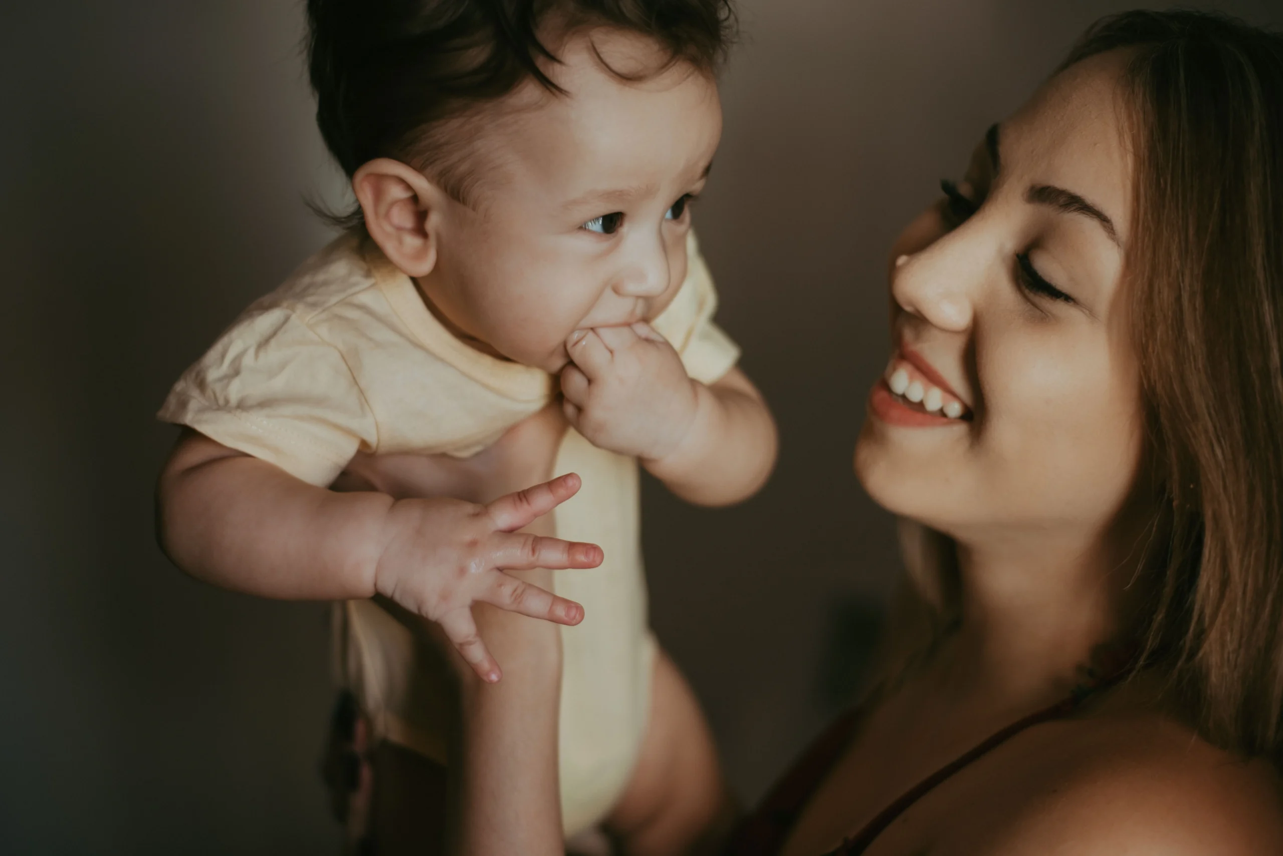 Mom experiencing back pain from carrying baby during daily activities.